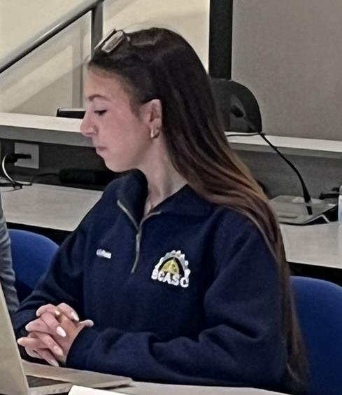 A student task force member at the boardroom table during the discussion